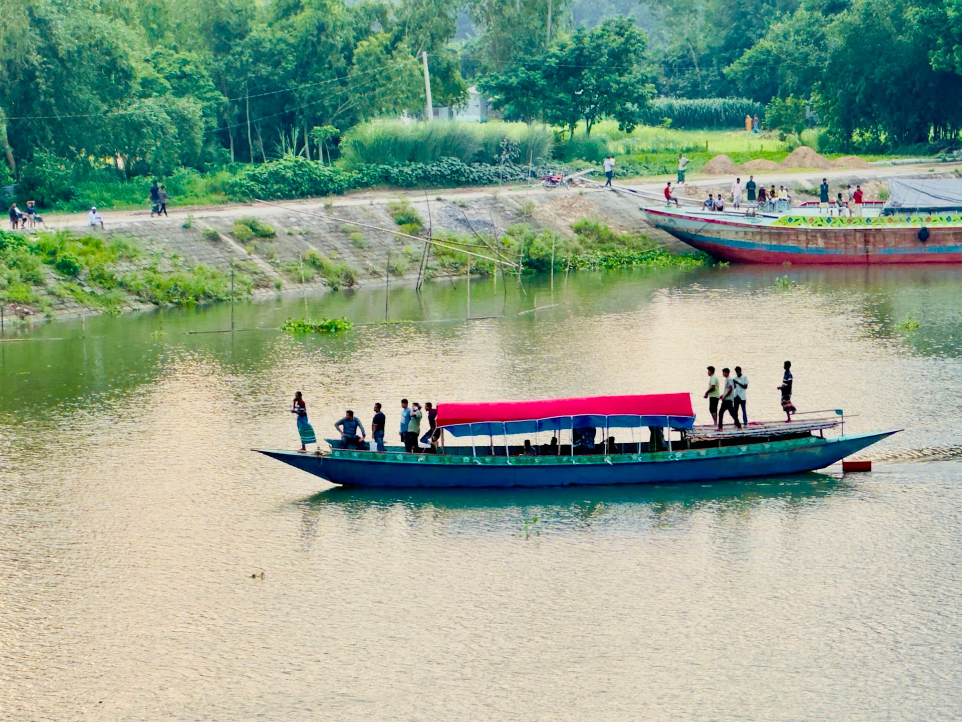 Wide river in Bangladesh with traditional boats